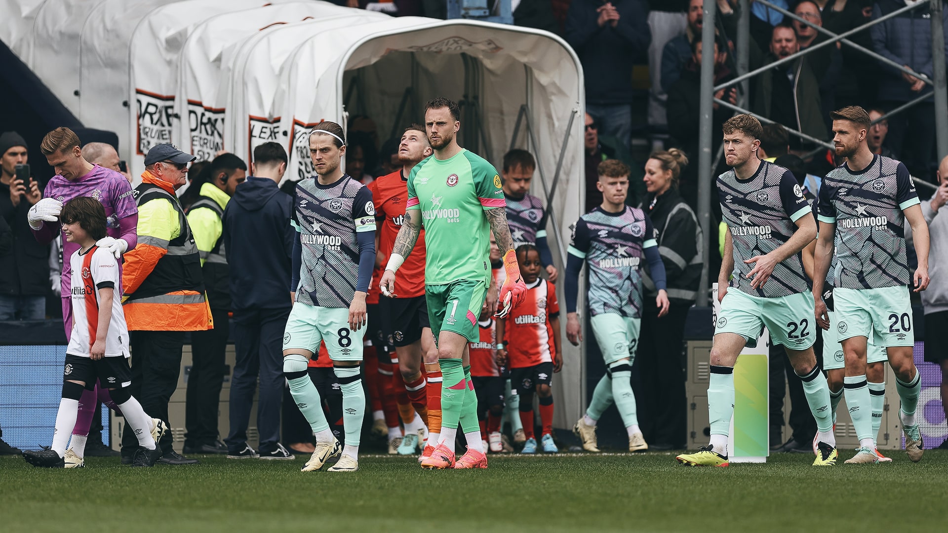 Into the action: Mathias Jensen leads Brentford out